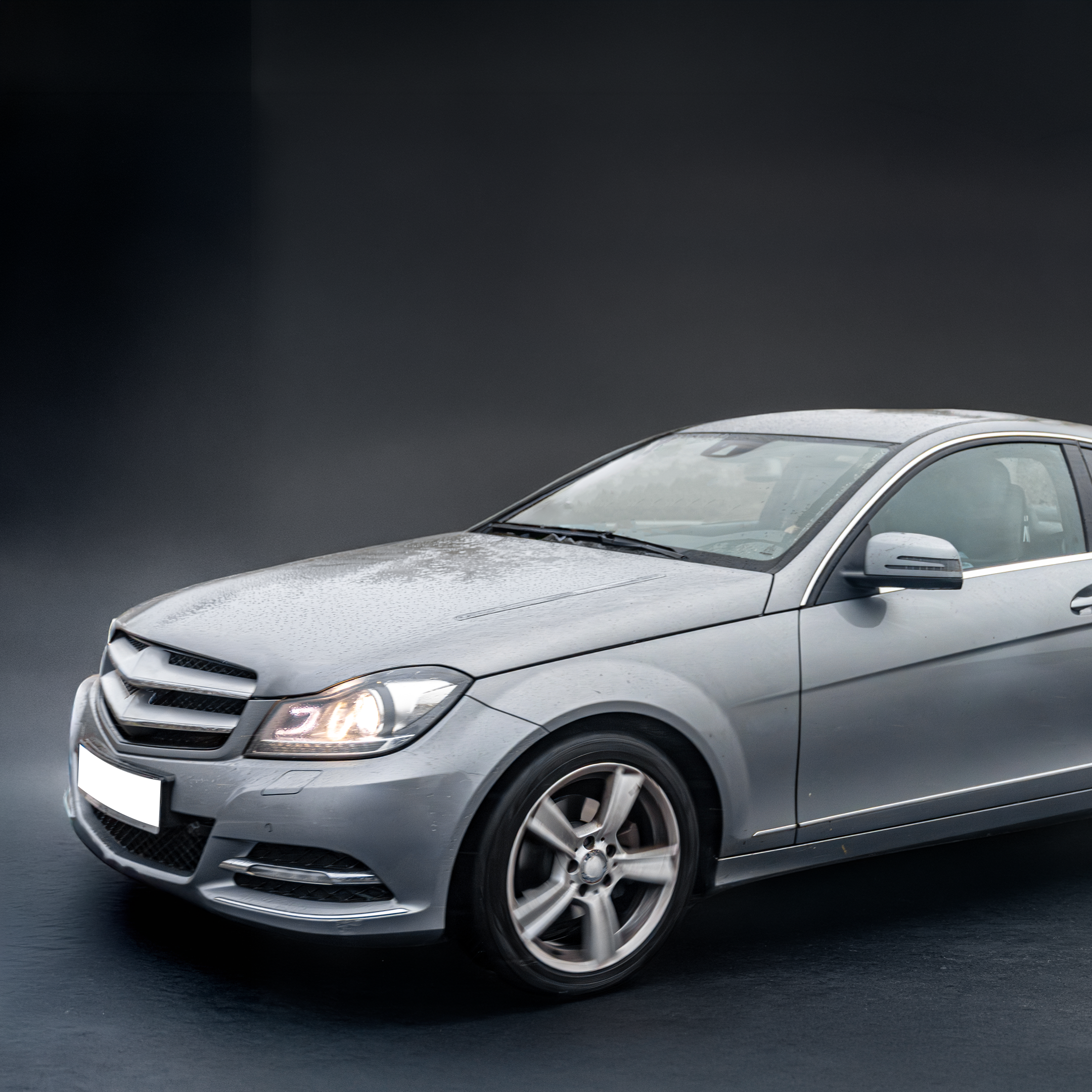 Modern high-end luxury sedan in a garage setting